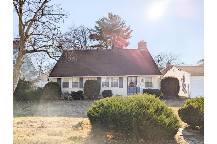 Cape cod home with a front yard