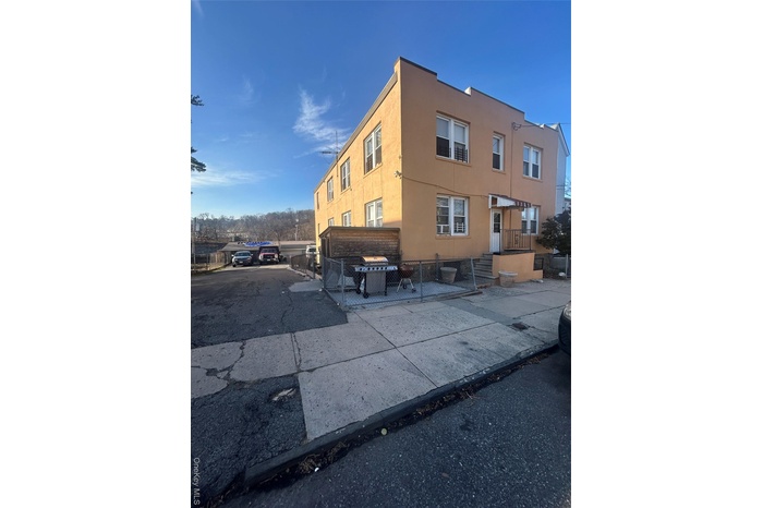 View of property exterior with stucco siding and a fenced front yard