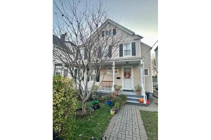 Traditional-style home featuring covered porch