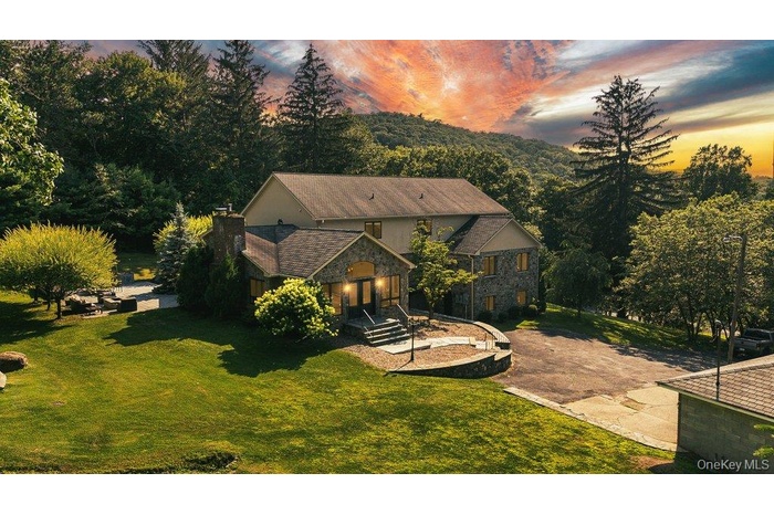 View of subject property with a forest