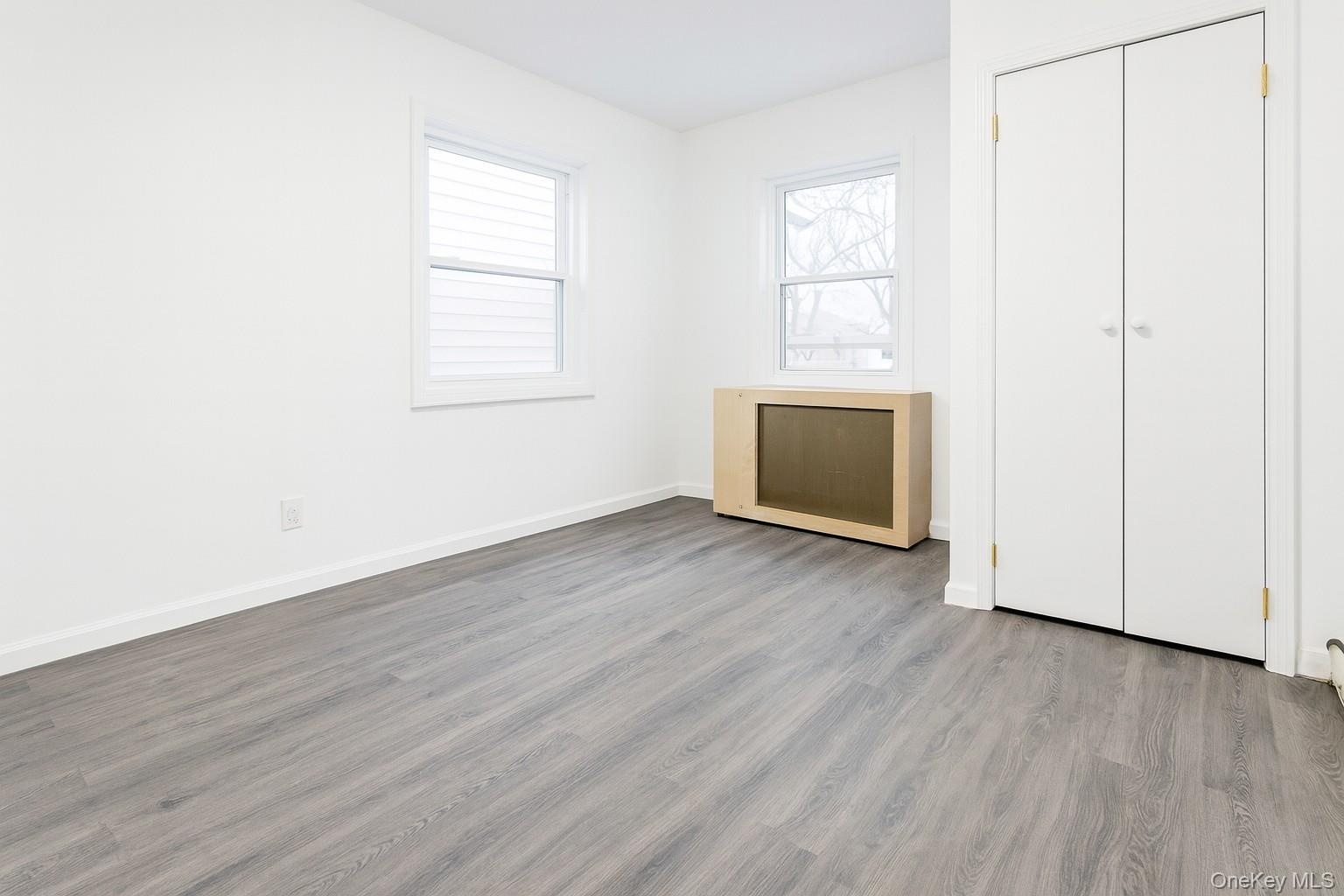Unfurnished bedroom featuring wood finished floors and a closet