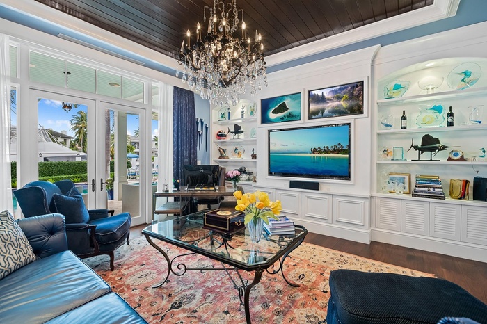 The beautiful family room is a true showstopper, featuring a stunning original artwork by Guy Harvey.
