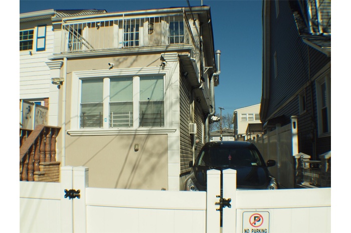 View of home's exterior with a balcony and fence