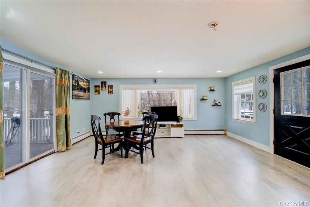 An open-concept kitchen seamlessly connects to a cozy enclosed porch, creating the perfect space for family gatherings and entertaining.