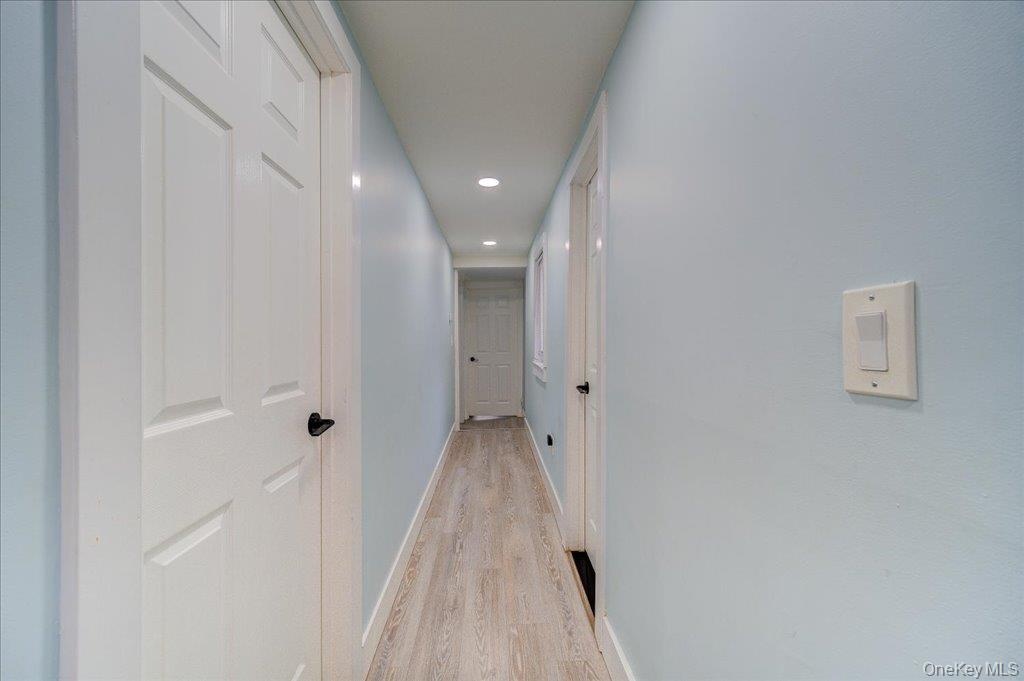 The upper level features a hallway connecting three bedrooms and a laundry room.