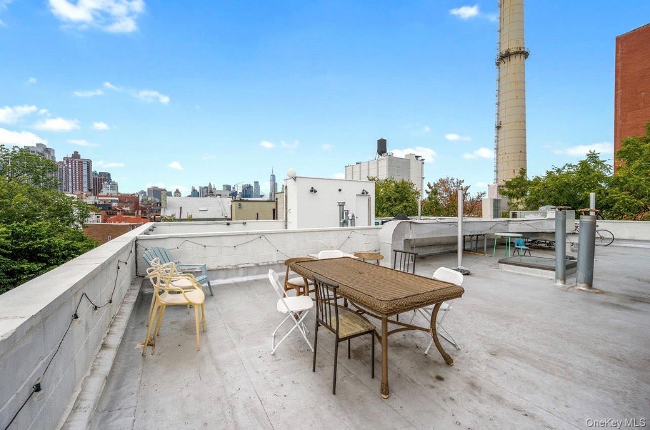 View of patio / terrace featuring a skyline view and outdoor dining space