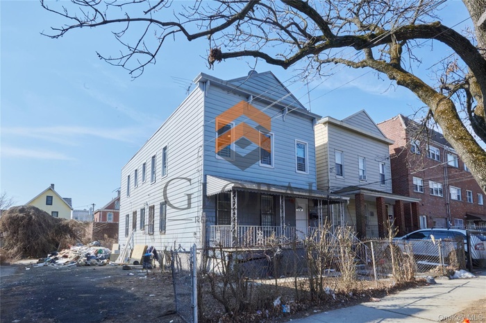 View of front of house featuring a fenced front yard, a residential view, and a porch