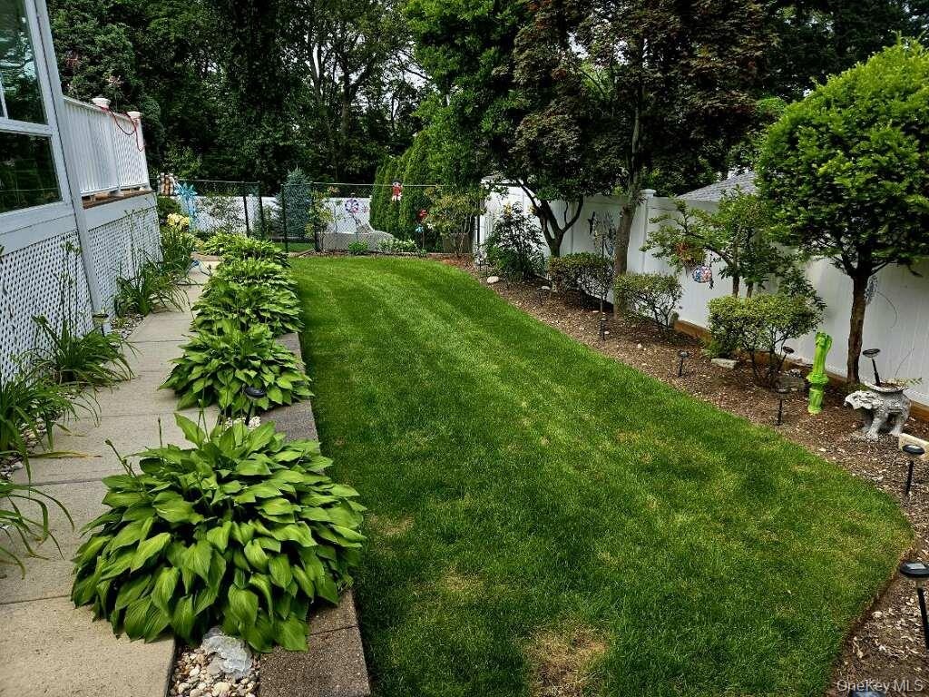 Backyard with retaining wall, igs, and specimen plantings