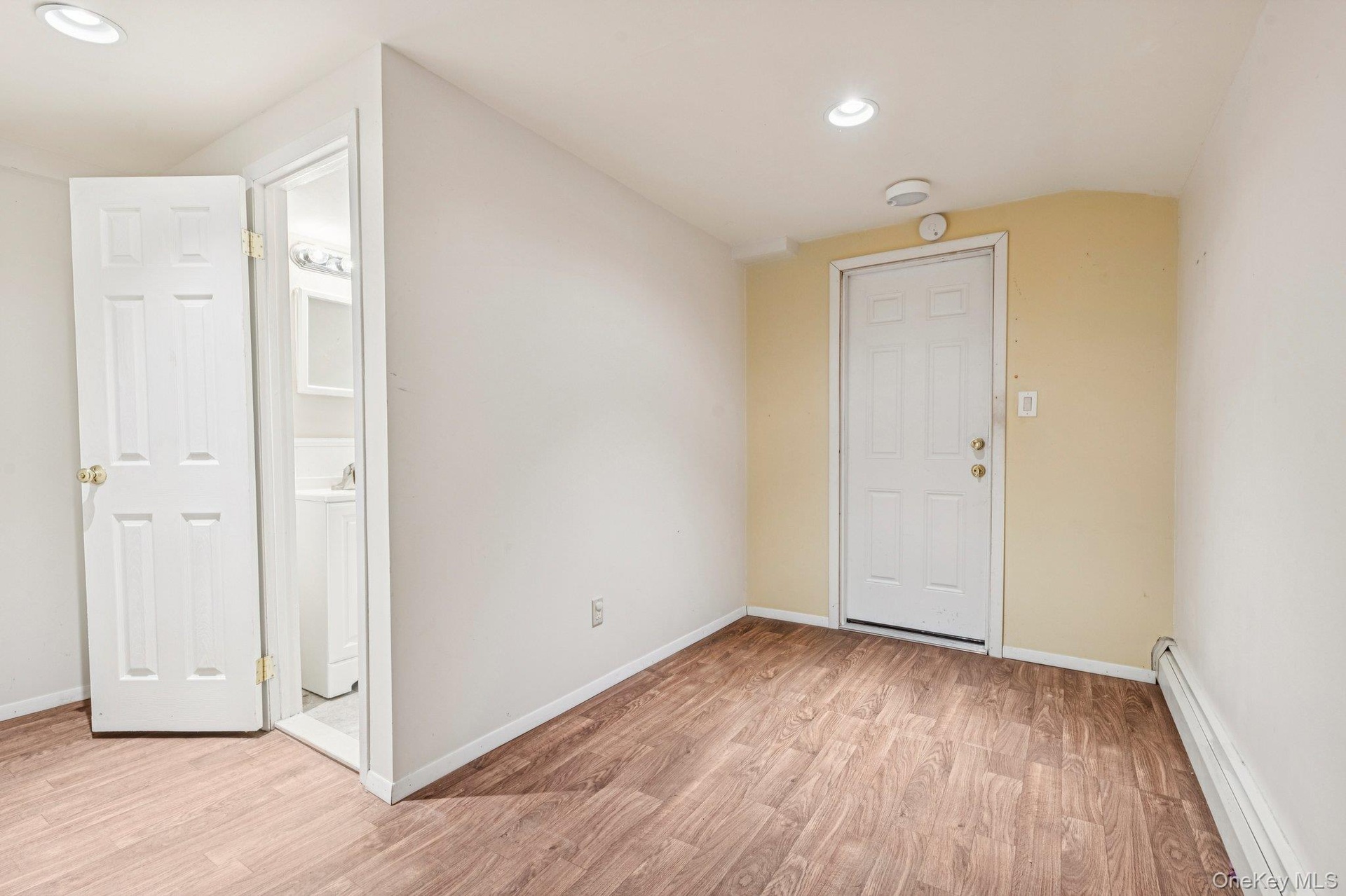 Lower level room with entrance to one of the 2 garages