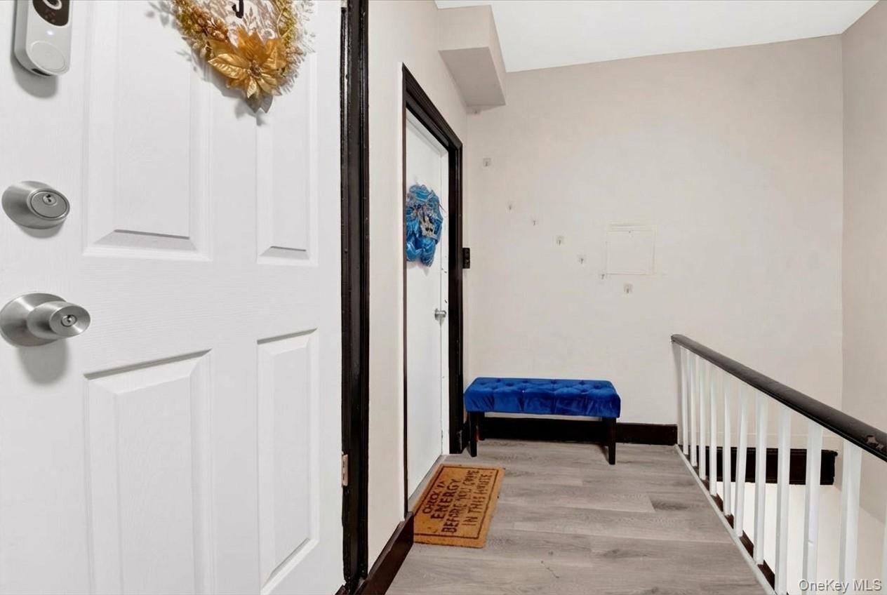 Corridor featuring light wood-style flooring