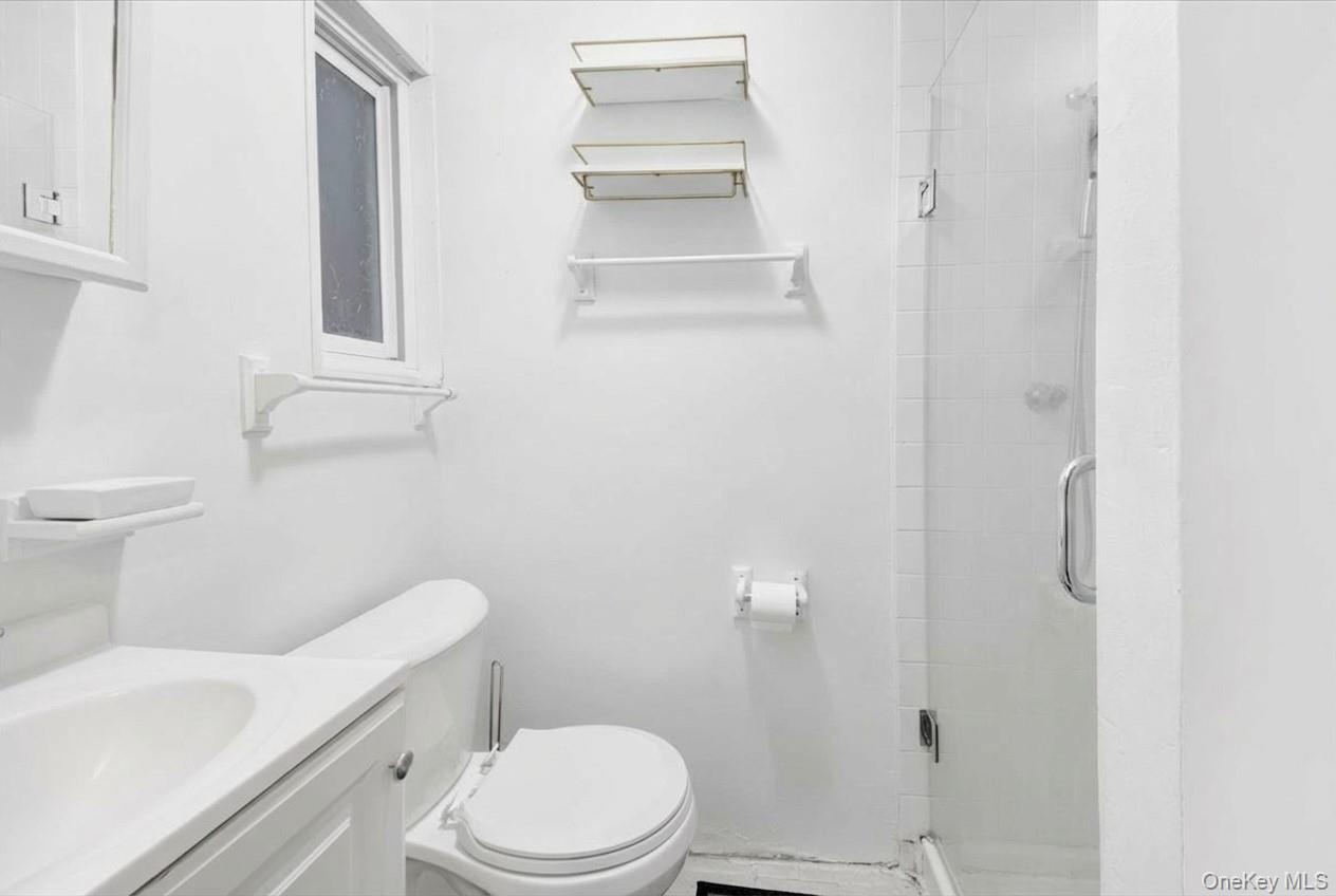 Bathroom featuring a stall shower and vanity