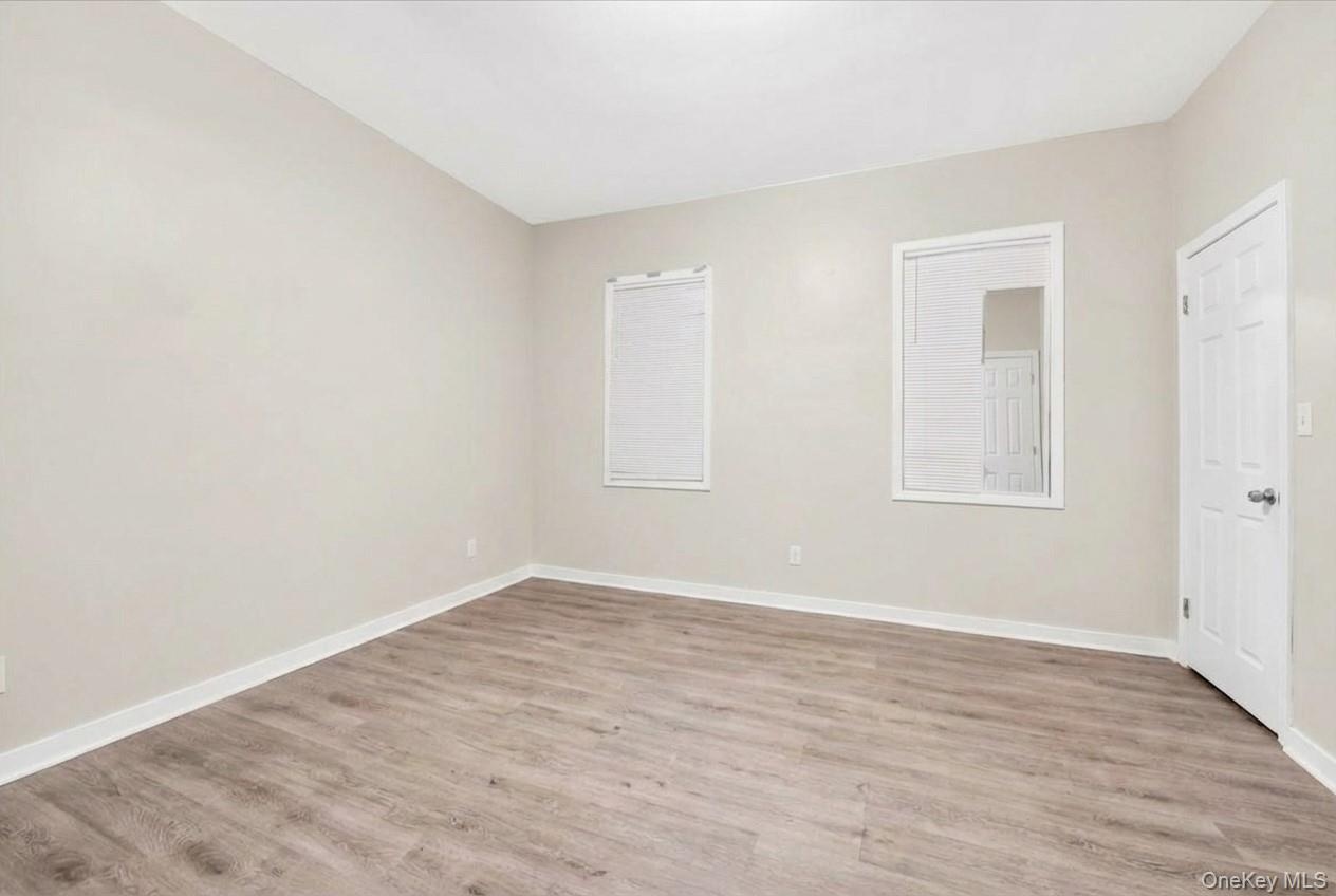 Bedroom featuring light wood-style flooring and baseboards