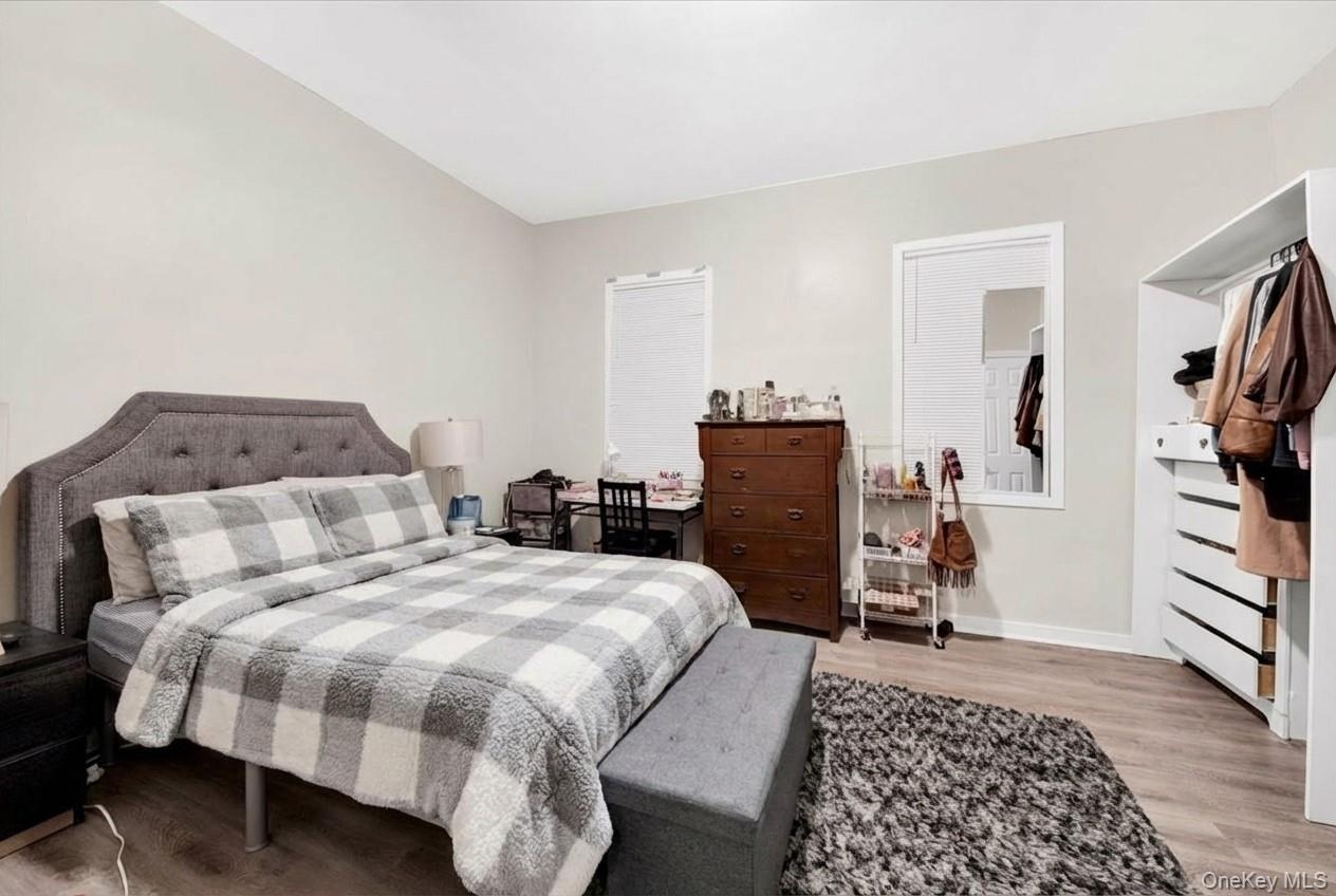 Bedroom with light wood-style floors and baseboards