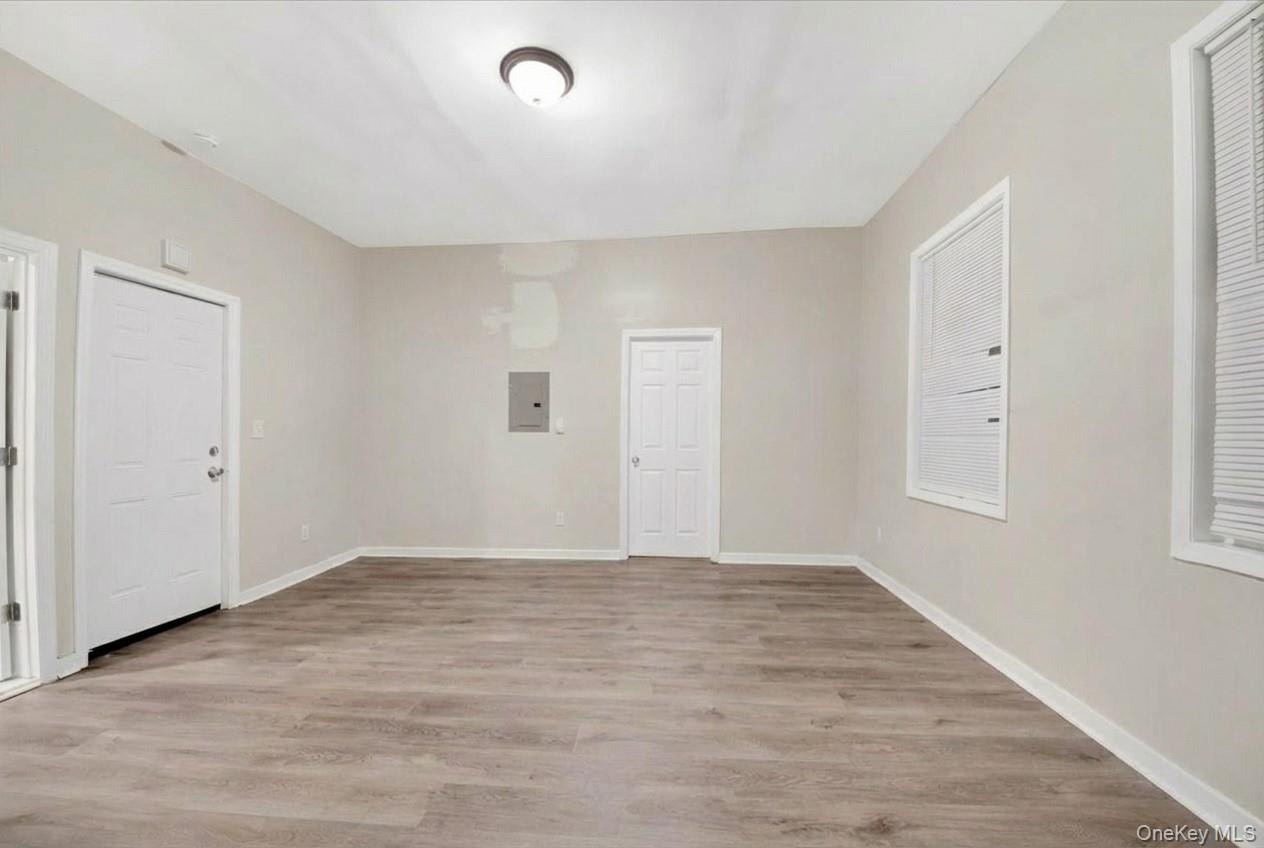 Entrance foyer with light wood-style floors and electric panel