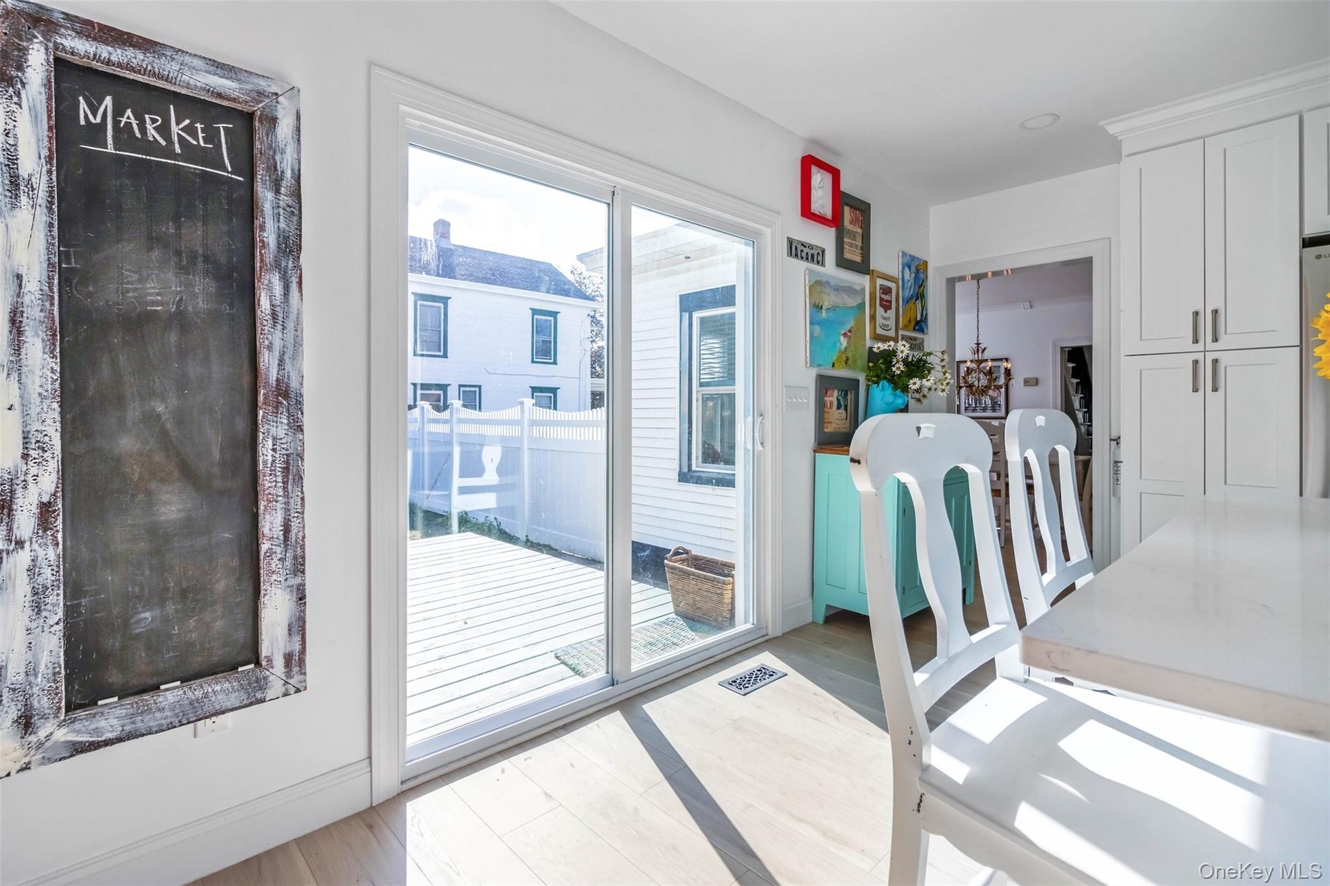 Doorway to outside with wood finished floors and baseboards