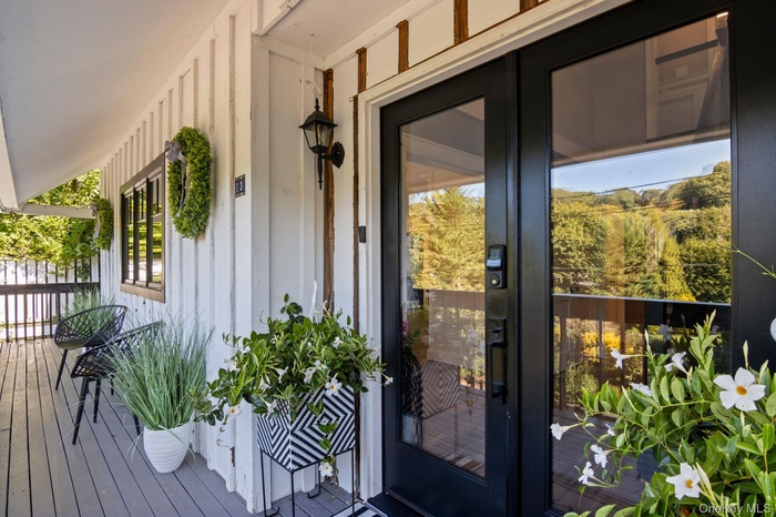 Property entrance featuring french doors and wrap around porch.