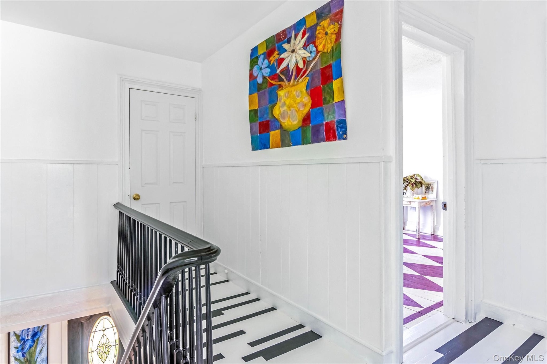 Stairway featuring wainscoting