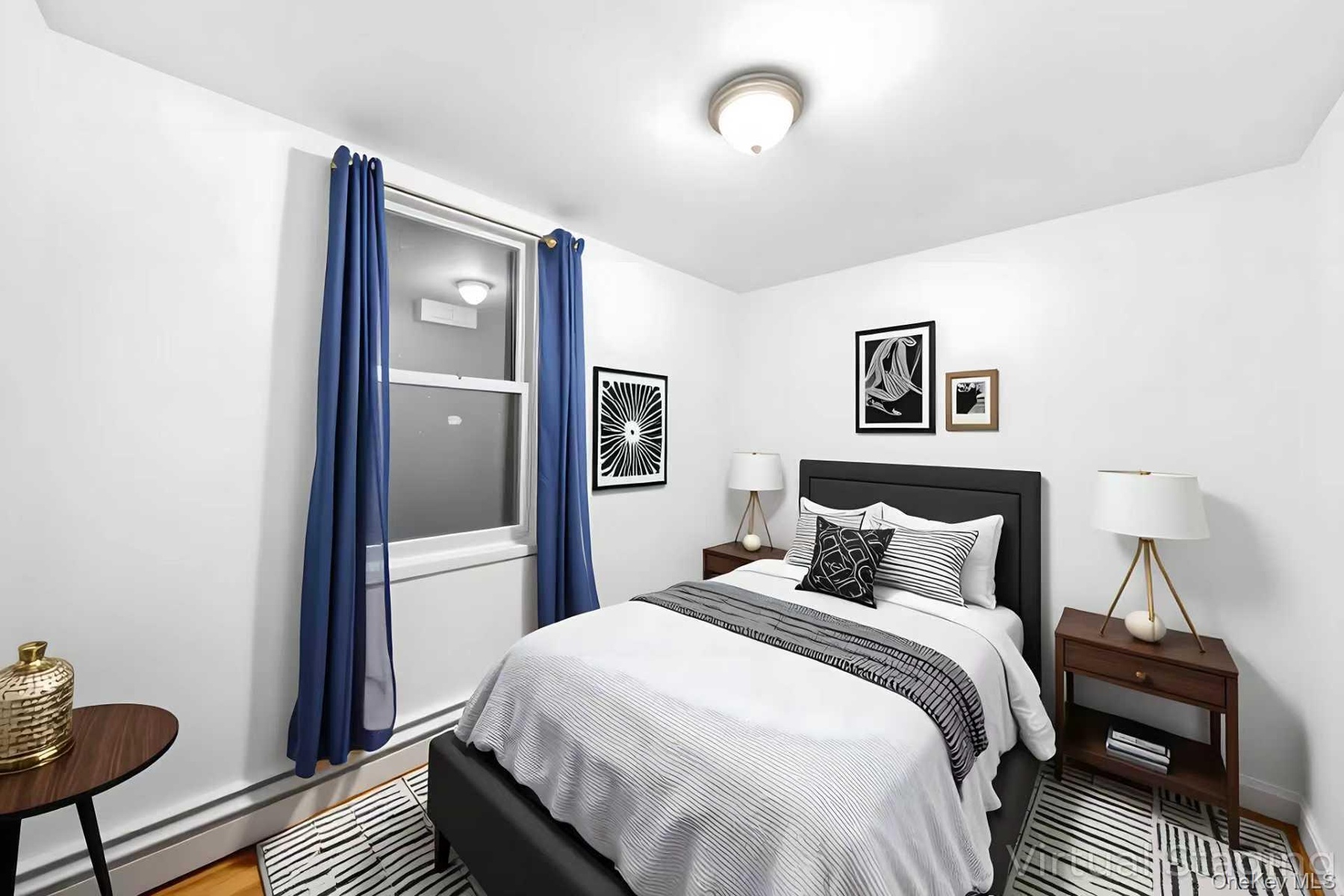 Bedroom featuring a baseboard radiator and baseboards