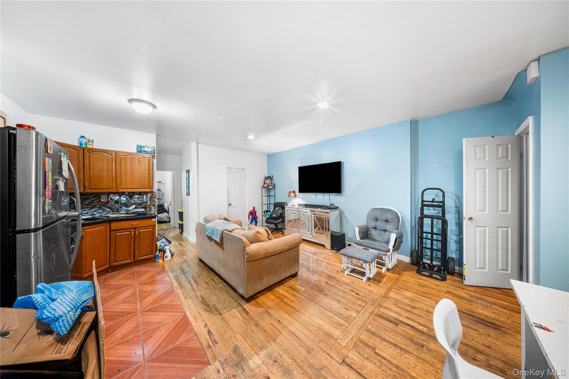 Living area with light wood-style flooring and recessed lighting