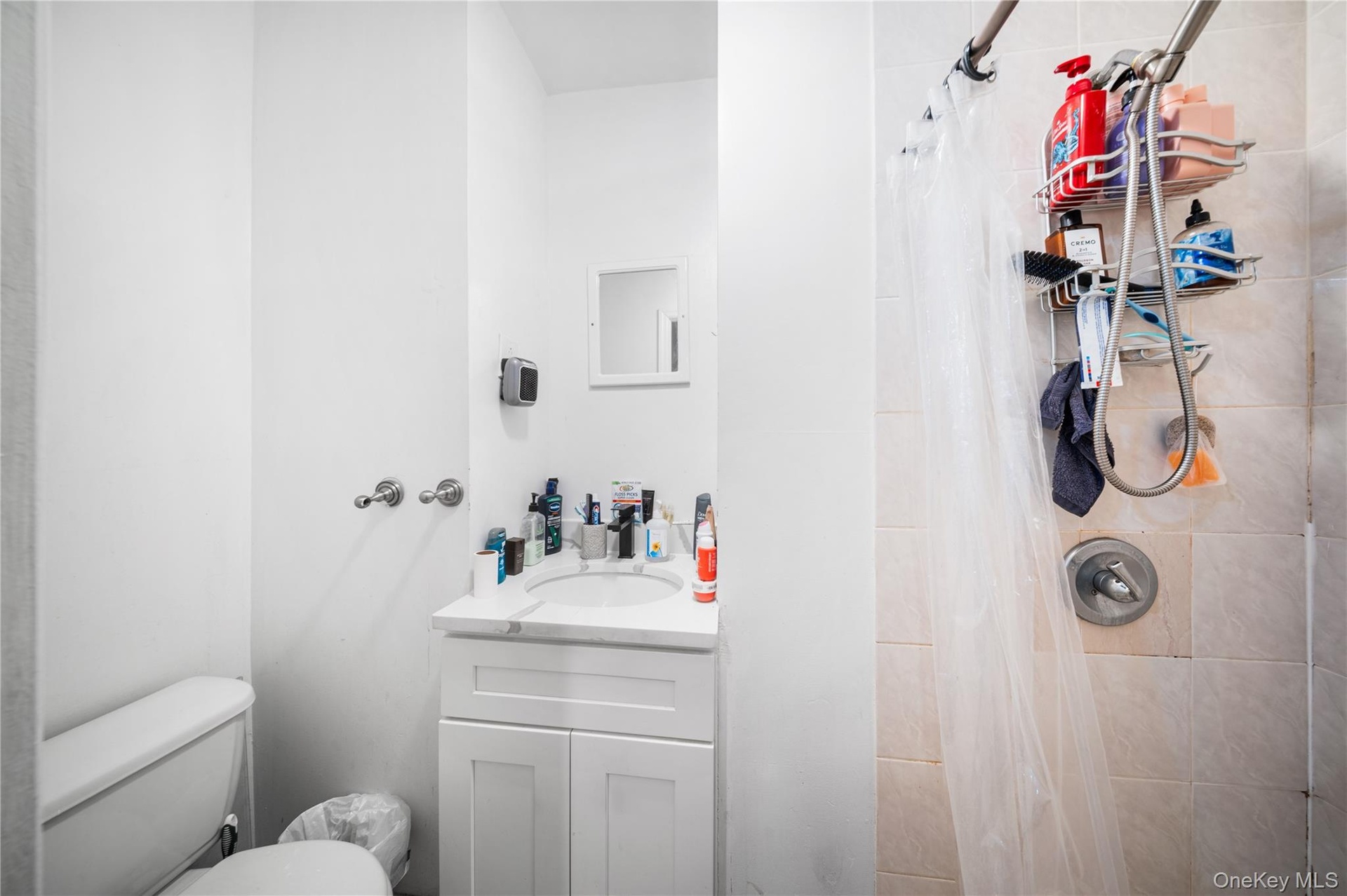 Full bath with a shower stall and vanity