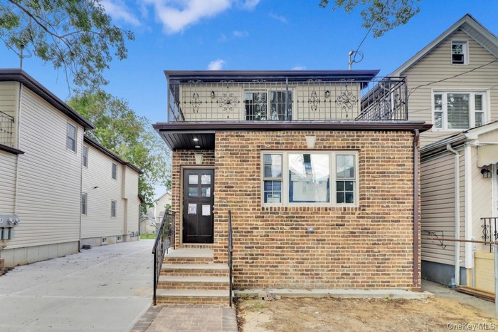 View of front of house with brick siding