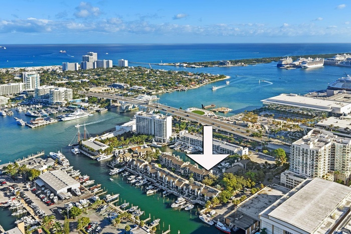 AERIAL VIEW OF PORTSIDE YACHT CLUB SHOWCASING 8 PORTSIDE DRIVE'S PREMIER HARBOR-BASIN LOCATION, MOMENTS TO THE INTRACOASTAL, OCEAN INLET, HILTON MARIN