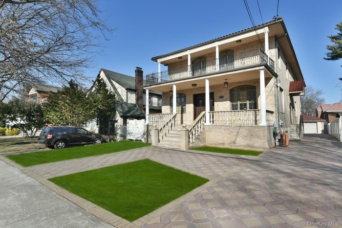 View of front facade featuring a balcony and a porch