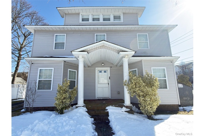 American foursquare style home featuring a porch