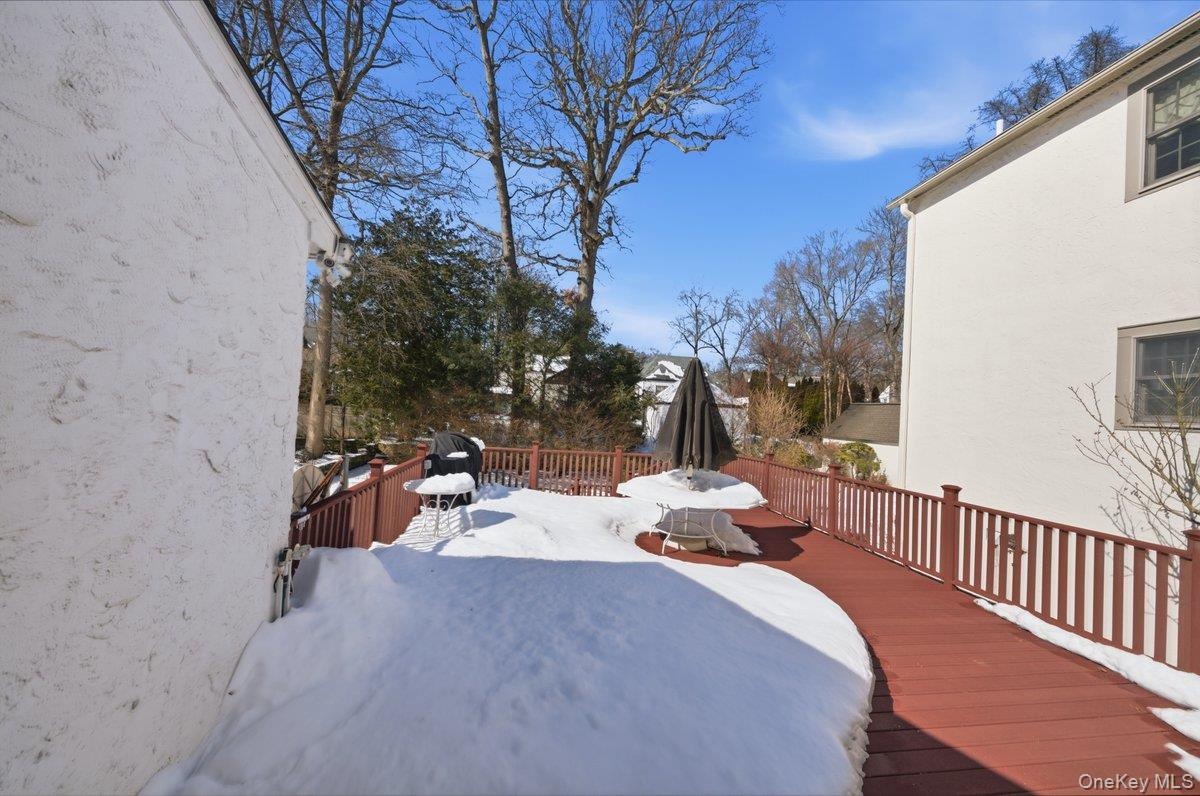 Expansive Trex deck with dining area and access to rear yard