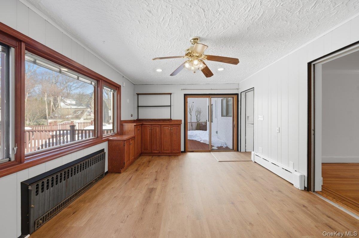 New LVP flooring ceiling fan, sliding glass doors to Trex deck