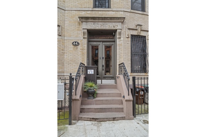 Doorway to property featuring brick siding