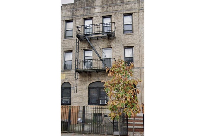 View of property featuring a fenced front yard