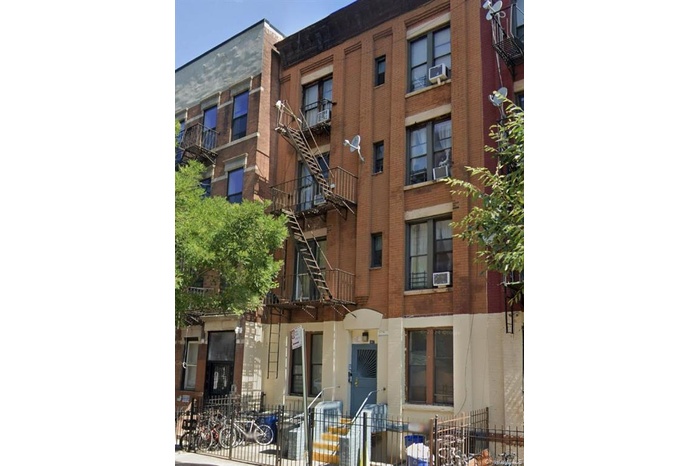 View of apartment building / complex featuring cooling unit