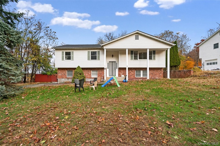 Bi-level home featuring brick siding
