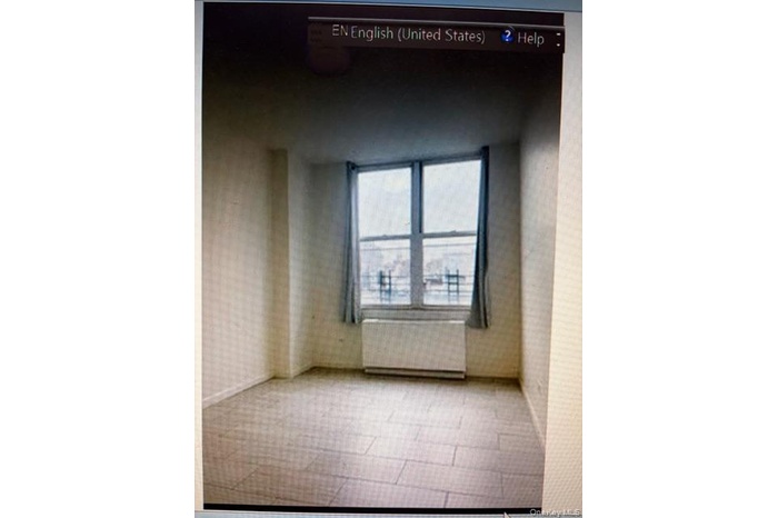 Spare room featuring radiator heating unit and wallpapered walls