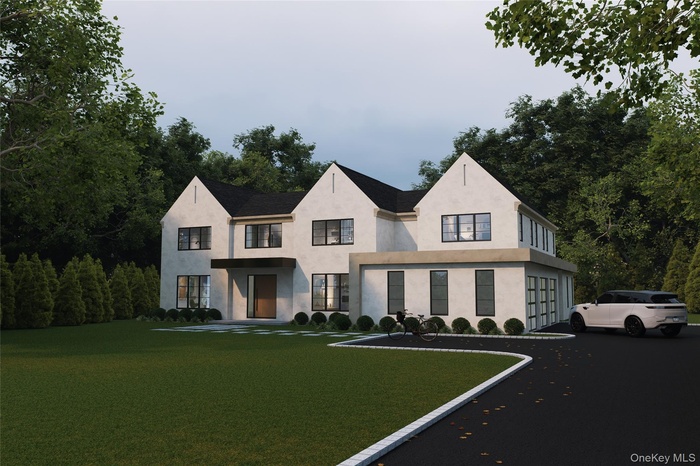 View of front of property with a front yard, asphalt driveway, stucco siding, and an attached garage