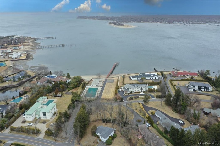 Aerial overview of property's location featuring nearby suburban area and a nearby body of water