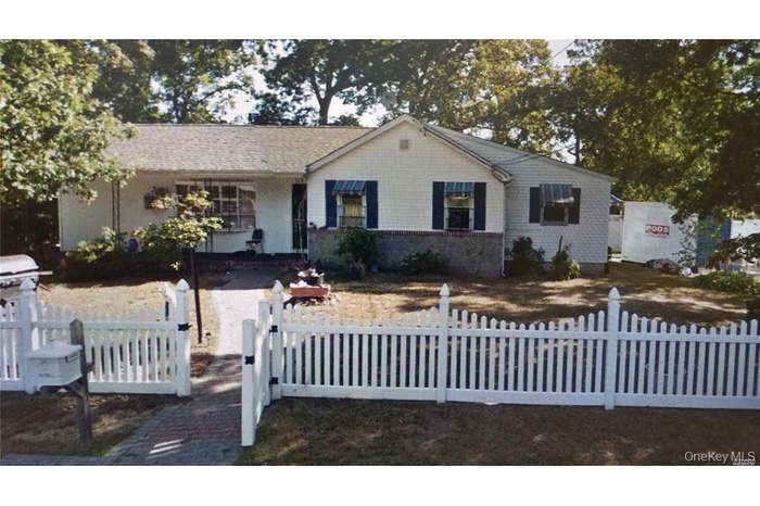 Ranch-style home with a fenced front yard