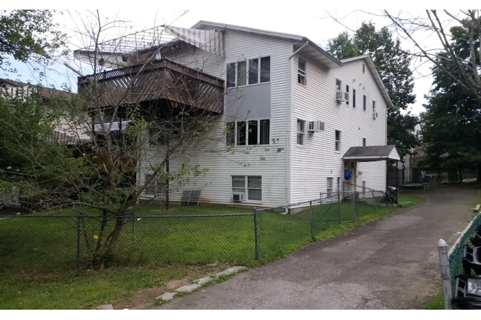View of side of home featuring a fenced front yard