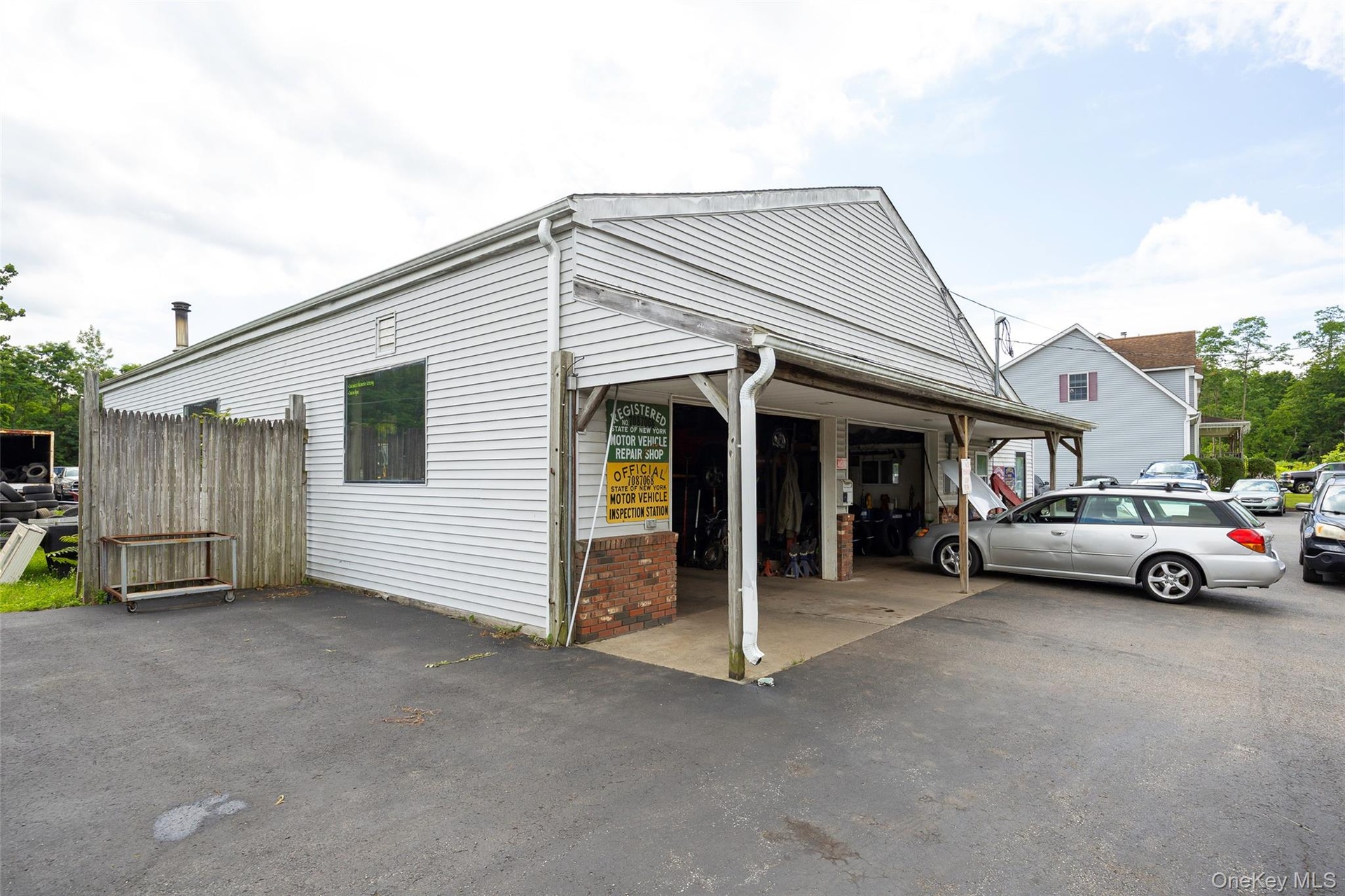 View of property exterior featuring asphalt driveway