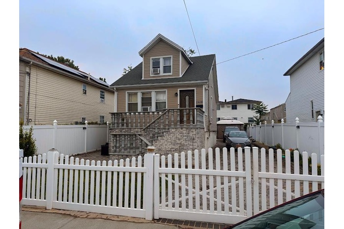 Bungalow-style home featuring a fenced front yard