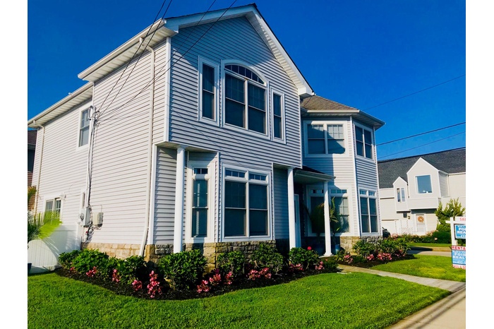 View of side of property with a yard