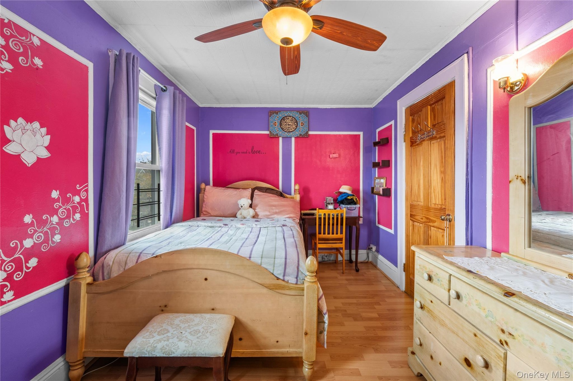 Bedroom with light wood-style flooring, a ceiling fan, and ornamental molding