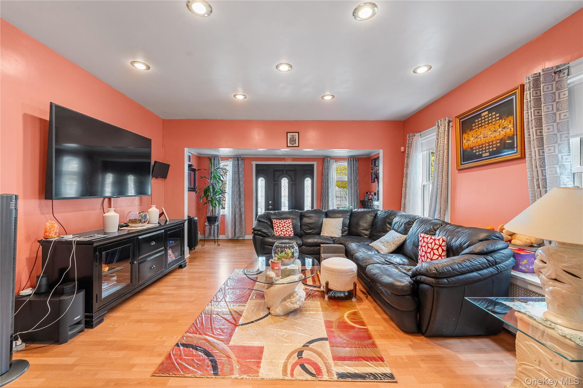 Living area with recessed lighting and light wood-style flooring