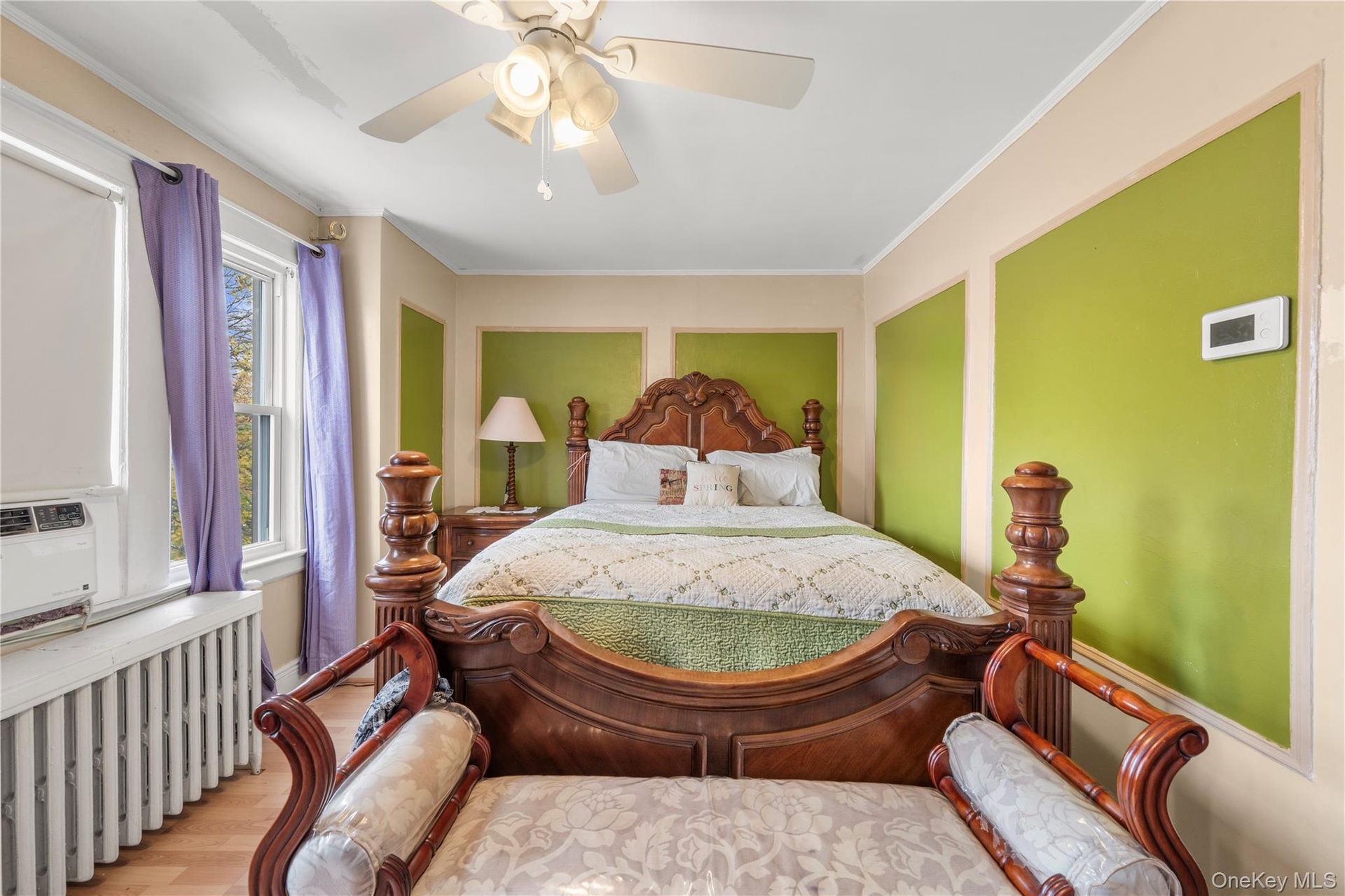 Bedroom with radiator, crown molding, wood finished floors, ceiling fan, and cooling unit