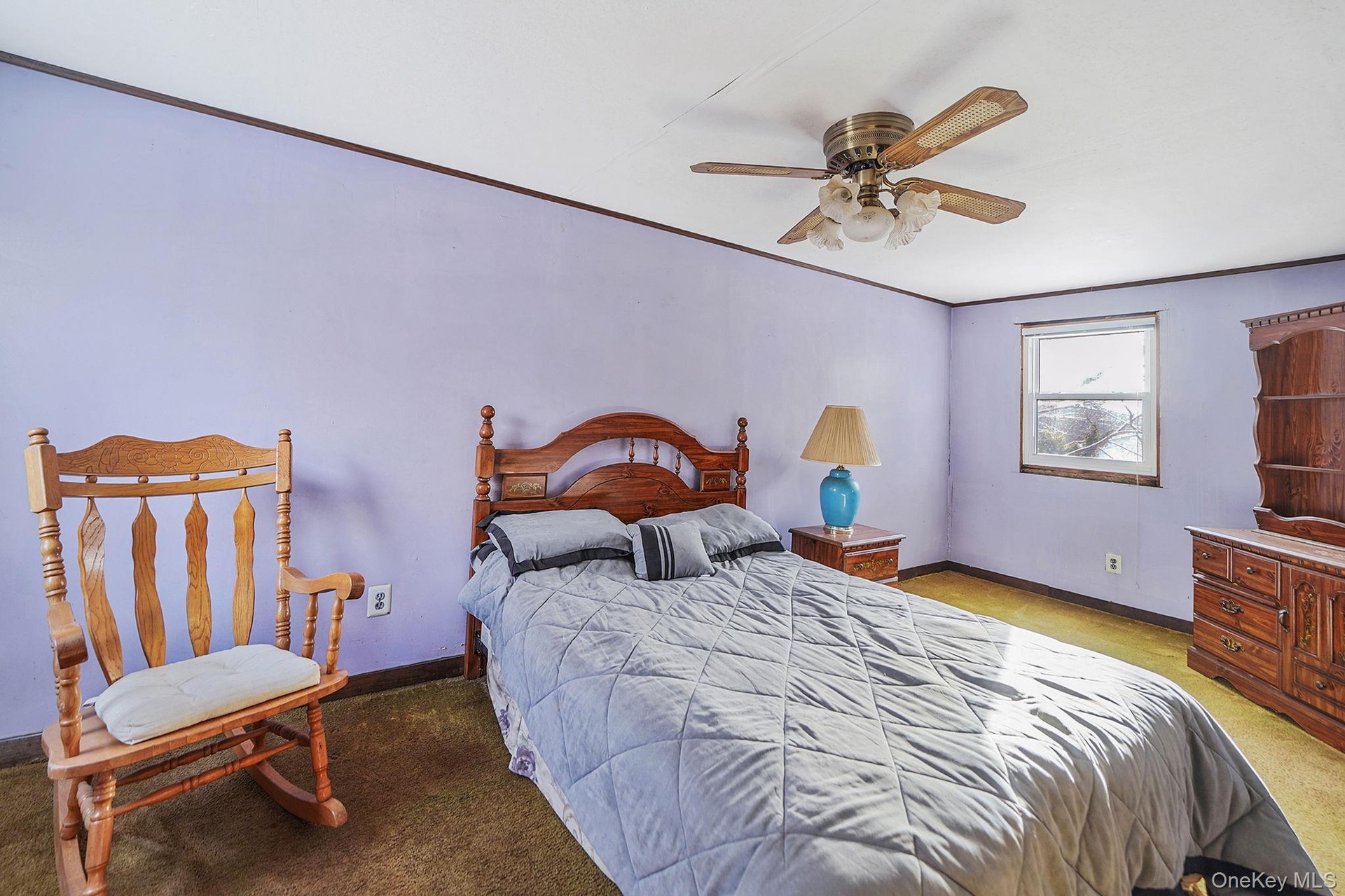 Bedroom featuring a ceiling fan, crown molding, and light colored carpet