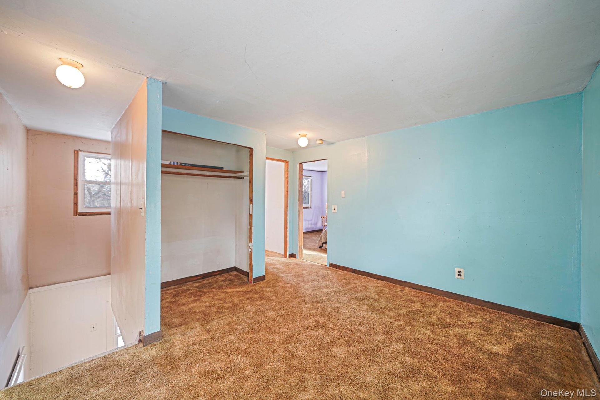 Unfurnished bedroom with a closet and carpet floors