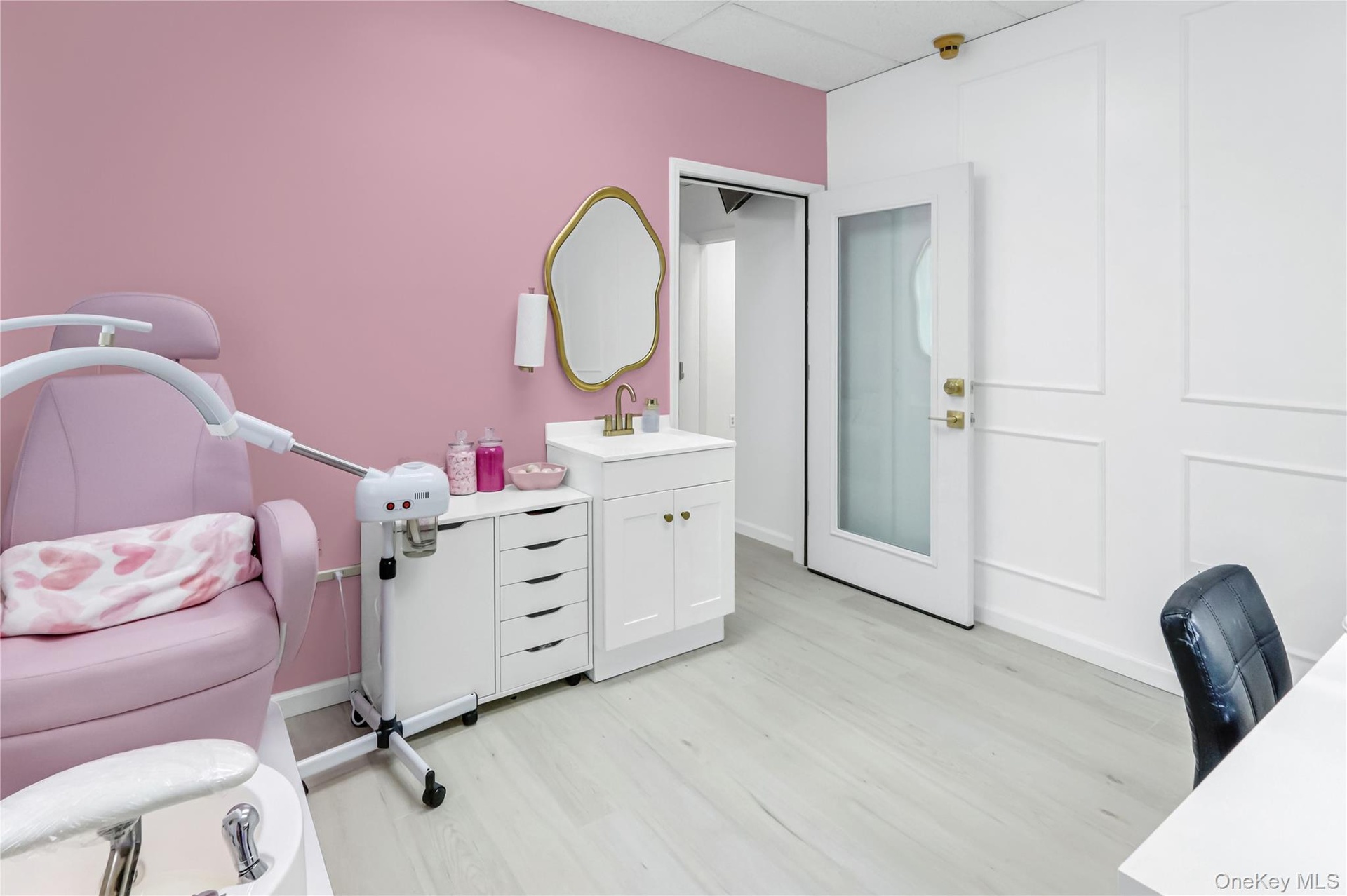 Bathroom with vanity, a paneled ceiling, and light wood-type flooring