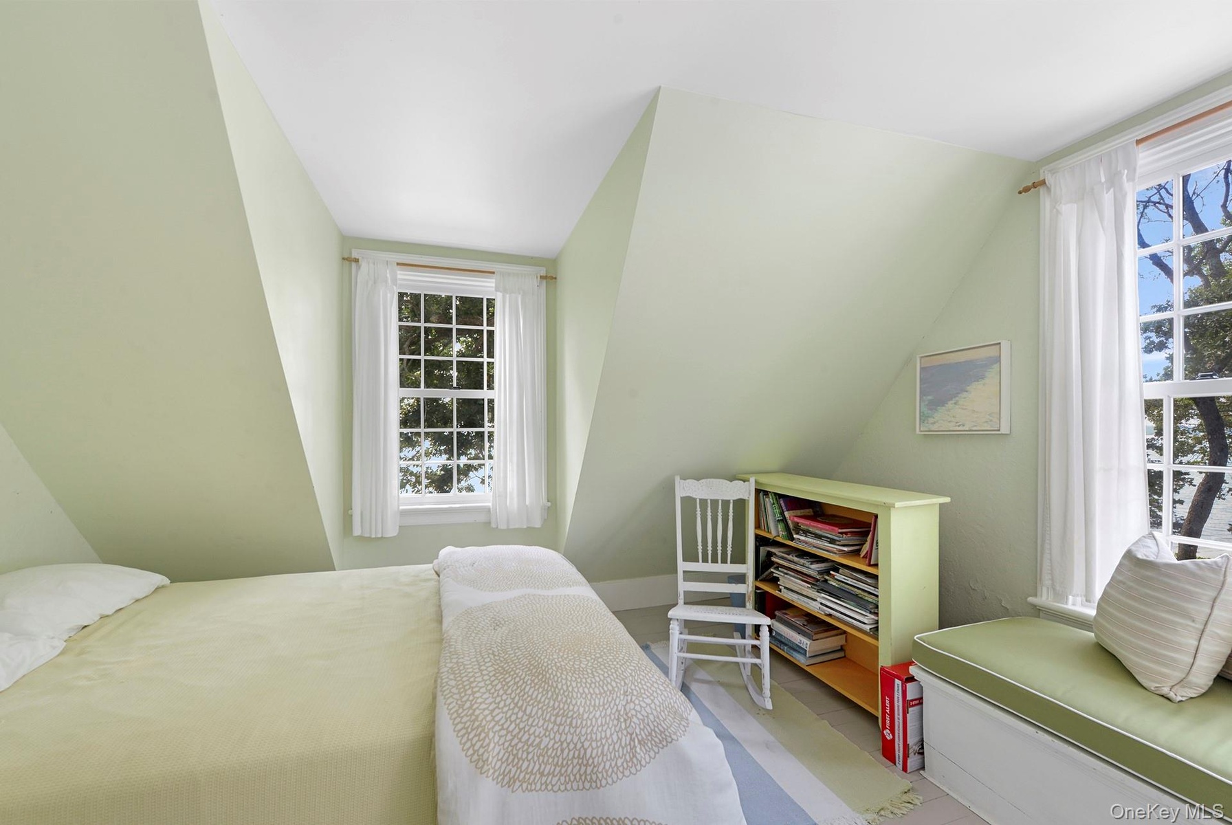 Bedroom featuring multiple windows and vaulted ceiling