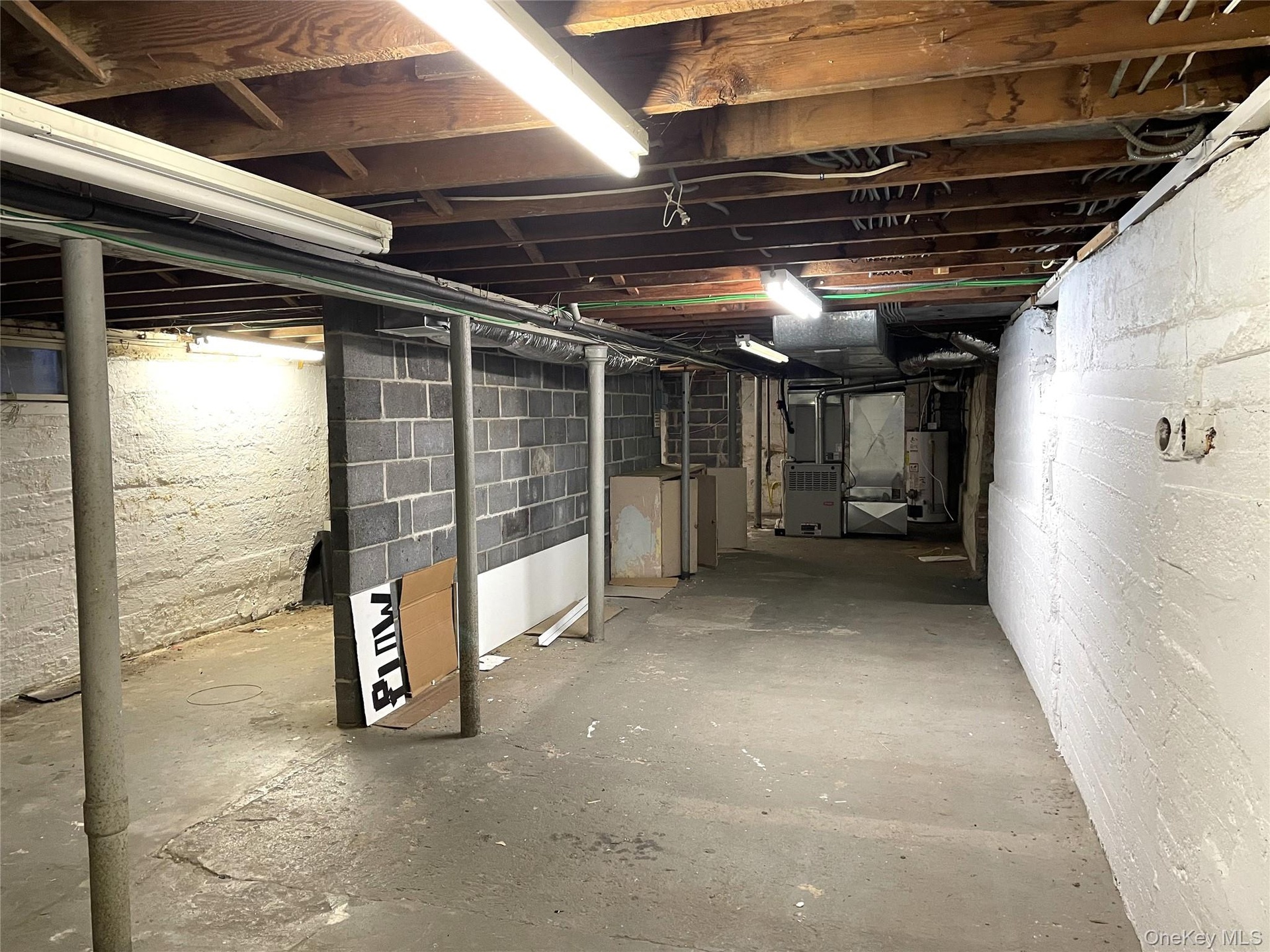 Unfinished basement with water heater and heating unit